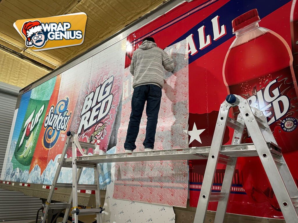 A professional adding a vehicle wrap to a semi-truck in Austin.